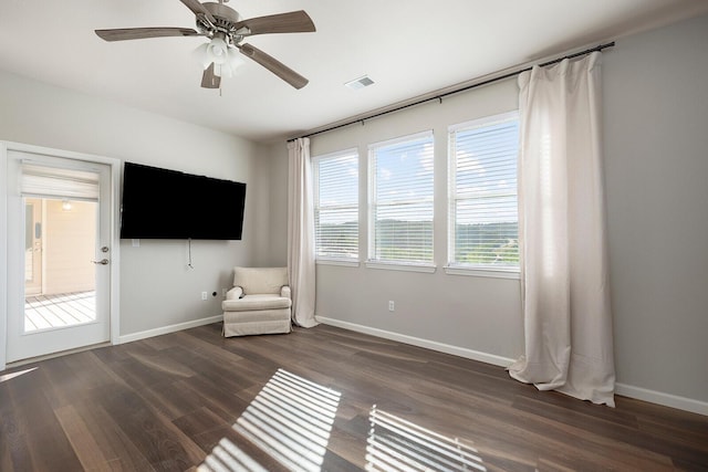 unfurnished room featuring ceiling fan and dark wood-type flooring