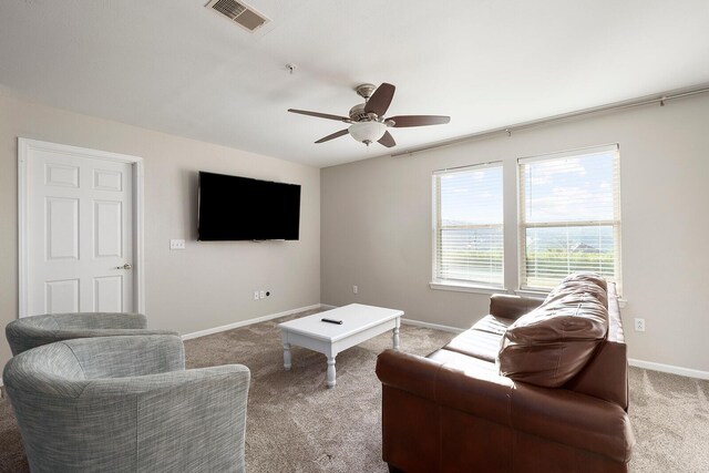 carpeted living room with ceiling fan