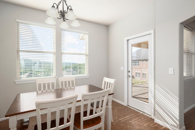 carpeted dining room featuring a chandelier and a healthy amount of sunlight