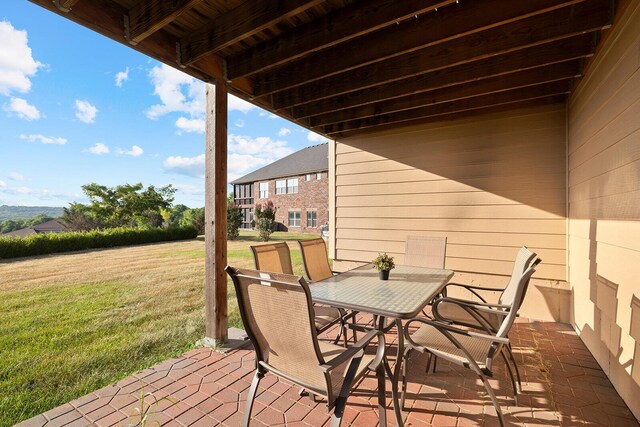 deck featuring a patio and a lawn