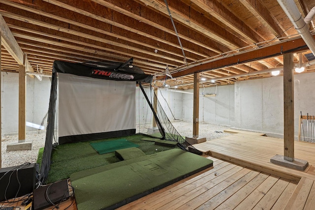 interior space with hardwood / wood-style floors and golf simulator