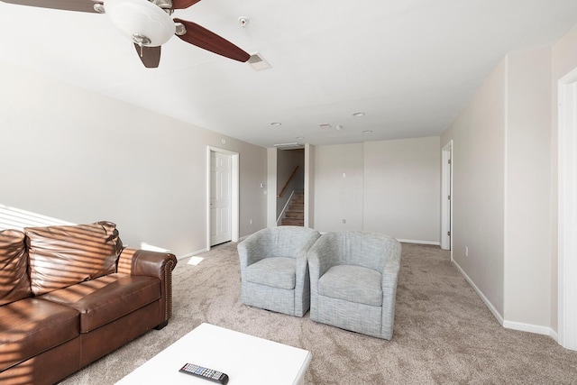 living room with ceiling fan and light colored carpet