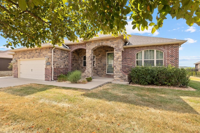 view of front of house with a garage and a front yard