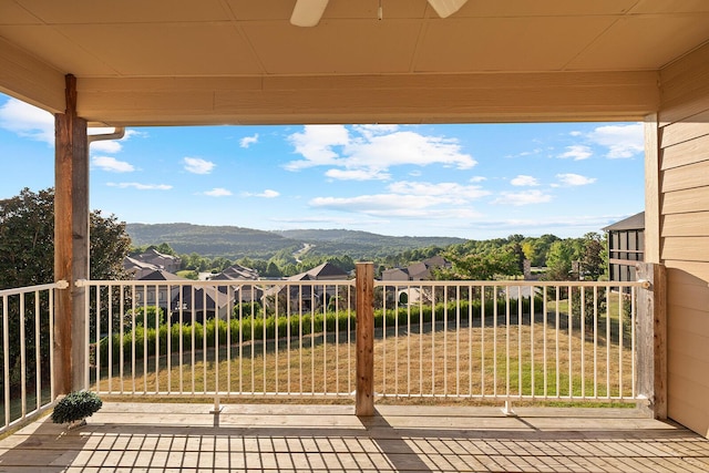 view of patio with a mountain view, a balcony, and ceiling fan