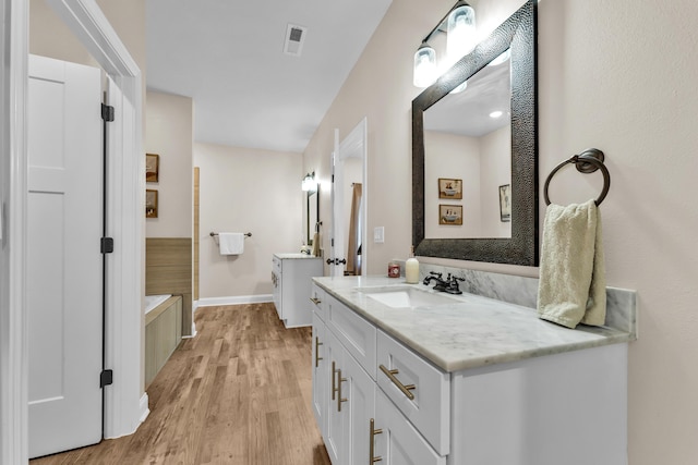 bathroom with vanity and hardwood / wood-style flooring