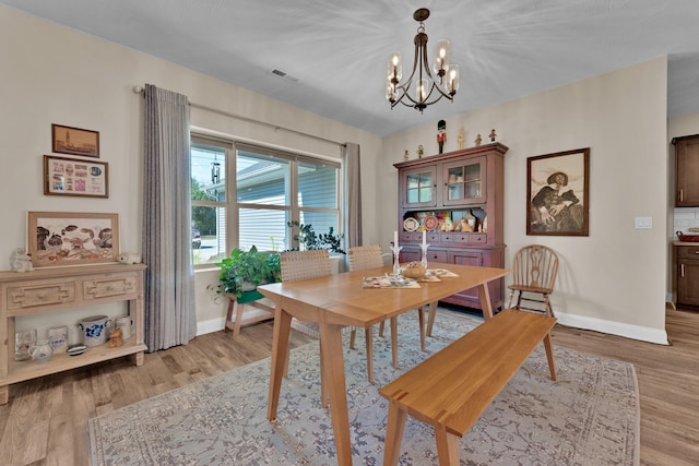 dining area featuring a chandelier and light hardwood / wood-style floors