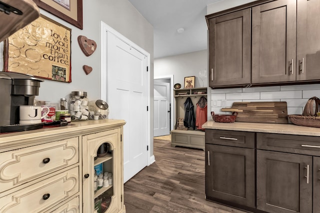 kitchen with backsplash, dark hardwood / wood-style floors, and dark brown cabinetry