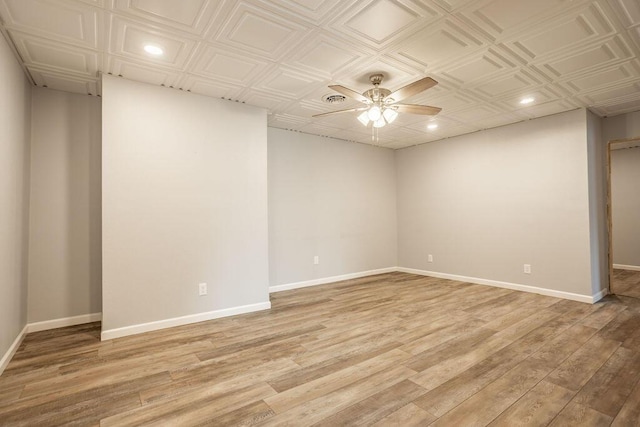 empty room featuring ceiling fan and light wood-type flooring