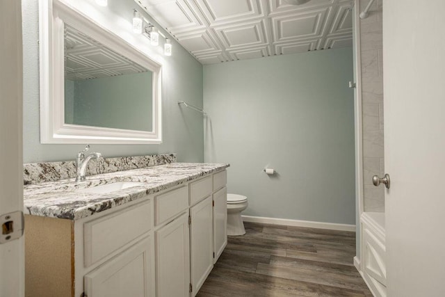 bathroom with vanity, hardwood / wood-style flooring, and toilet