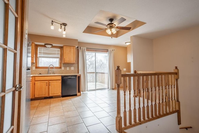 kitchen featuring light tile patterned flooring, tasteful backsplash, dishwasher, sink, and ceiling fan