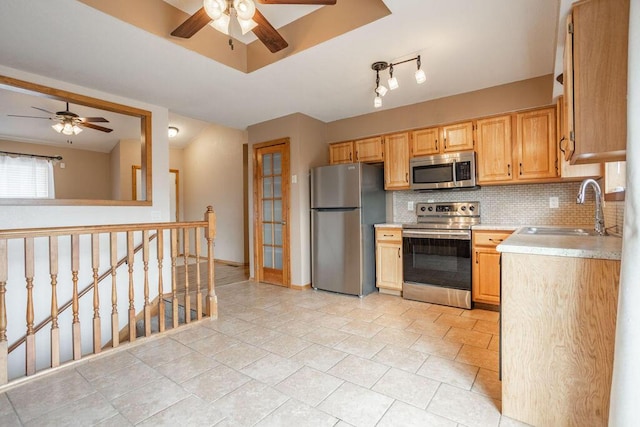 kitchen featuring sink, ceiling fan, appliances with stainless steel finishes, backsplash, and light brown cabinets