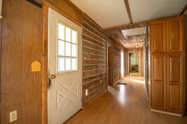 hall featuring wood-type flooring and wood walls