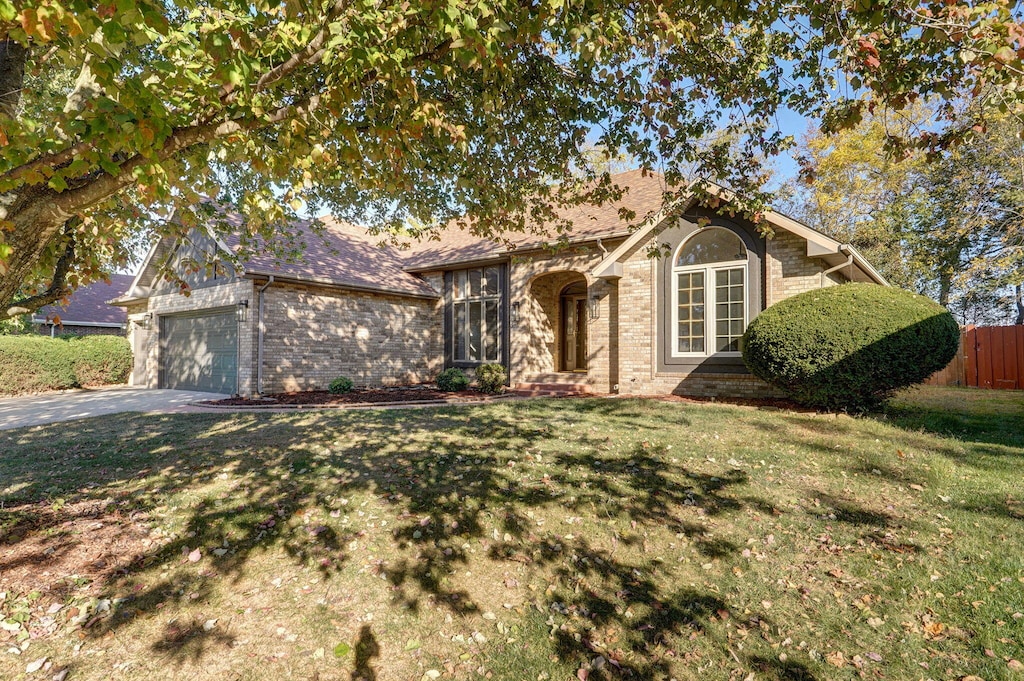 view of front facade with a garage and a front lawn