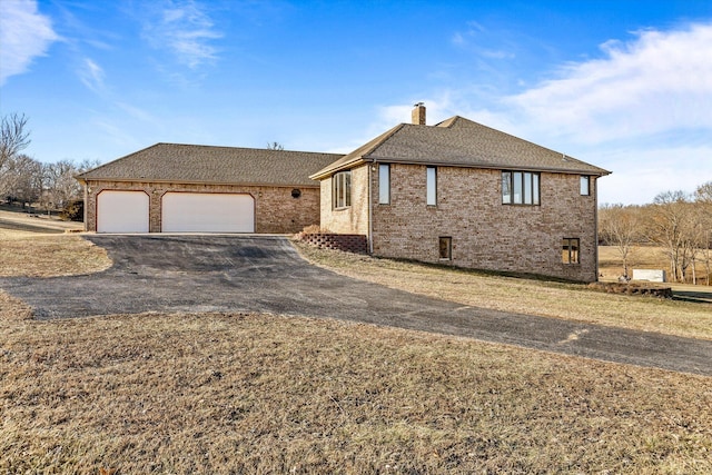 view of front of house with a garage and a front lawn