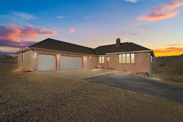 view of front facade with a garage and a yard