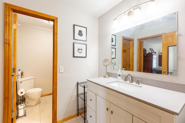 half bathroom featuring tile patterned floors, toilet, vanity, and baseboards