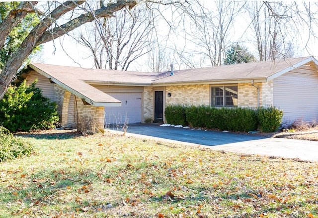 ranch-style house featuring brick siding, driveway, a front lawn, and a garage