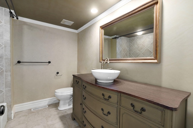 bathroom with ornamental molding, vanity, toilet, and tile patterned floors