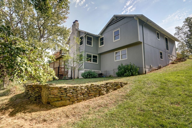 rear view of house with a yard