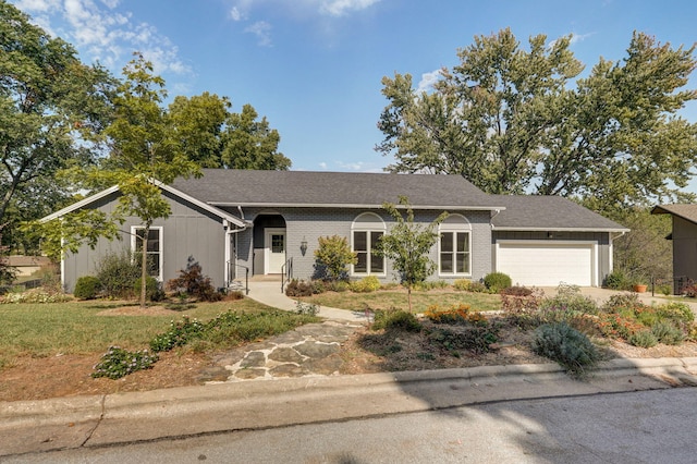 ranch-style house featuring a garage and a front yard