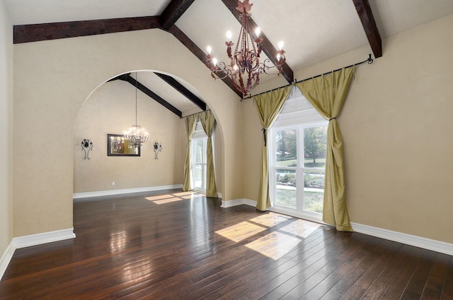 spare room with lofted ceiling with beams, dark hardwood / wood-style flooring, and a chandelier