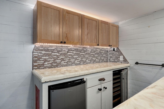 kitchen with wine cooler, light brown cabinetry, tasteful backsplash, and stainless steel refrigerator