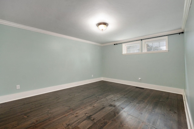 spare room with ornamental molding and dark wood-type flooring