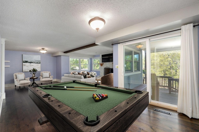 rec room with dark hardwood / wood-style flooring and a textured ceiling