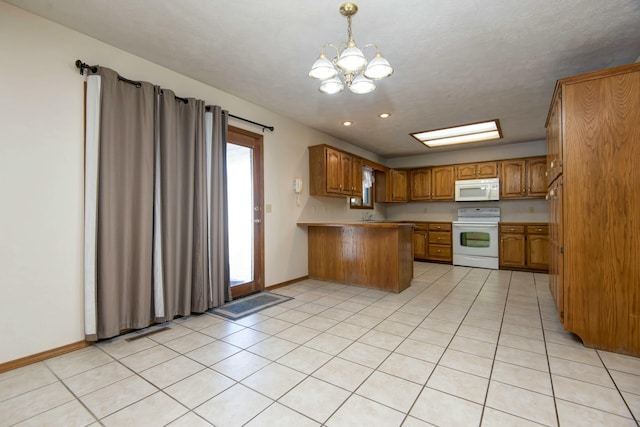 kitchen featuring pendant lighting, a chandelier, light tile patterned floors, kitchen peninsula, and white appliances