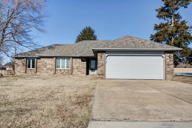 view of front of home with a garage and a front lawn