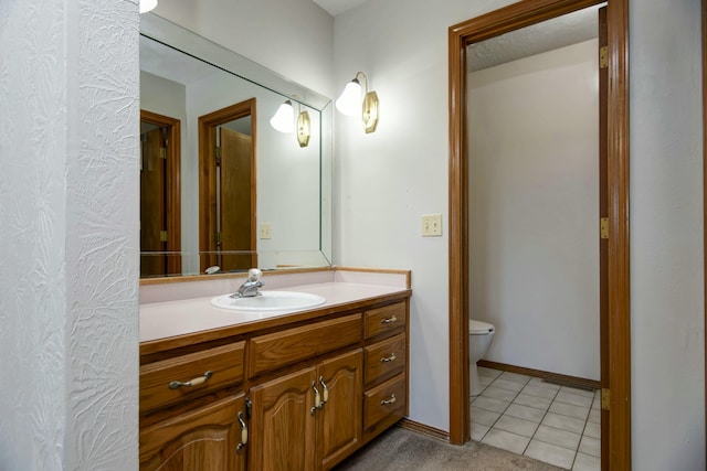 bathroom featuring tile patterned flooring, vanity, and toilet