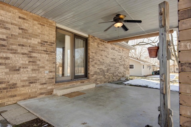 snow covered patio featuring ceiling fan