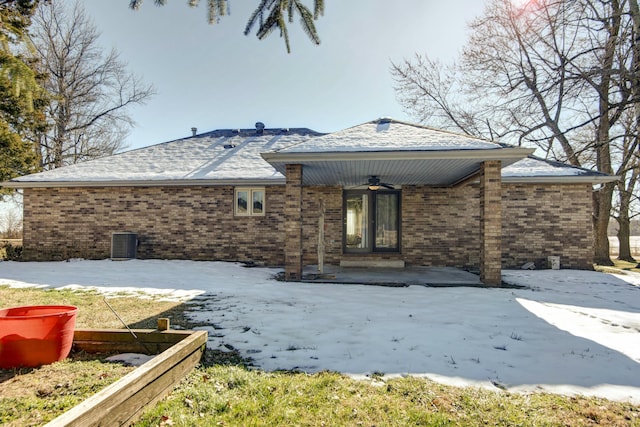 rear view of property with ceiling fan and central AC unit