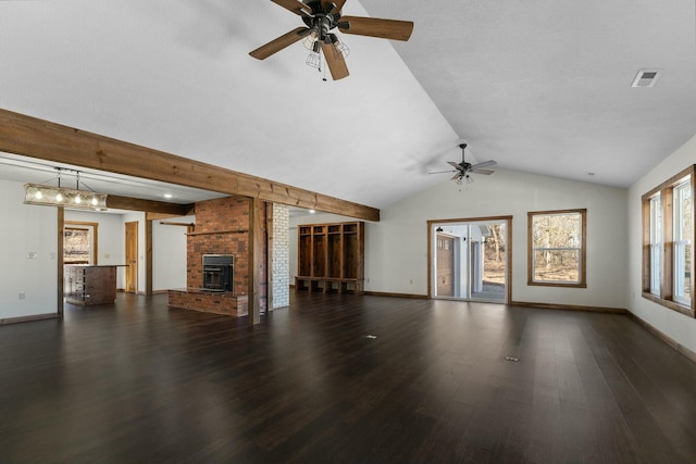 unfurnished living room with vaulted ceiling, a brick fireplace, dark wood-type flooring, and ceiling fan