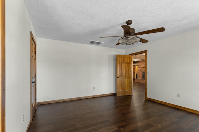 spare room featuring a textured ceiling, dark hardwood / wood-style floors, and ceiling fan