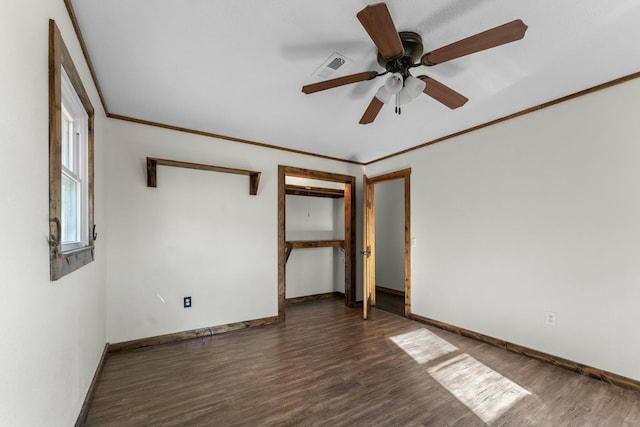 interior space with crown molding, ceiling fan, and dark hardwood / wood-style flooring