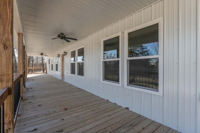 wooden terrace with covered porch and ceiling fan