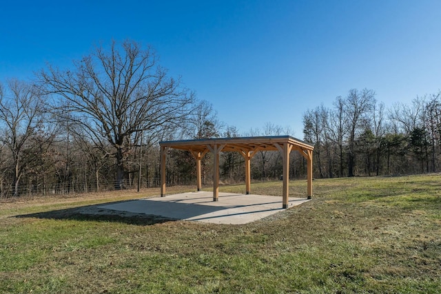 view of property's community with a yard and a patio area