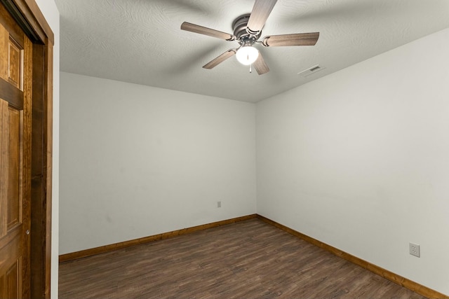 empty room with dark wood-type flooring and ceiling fan