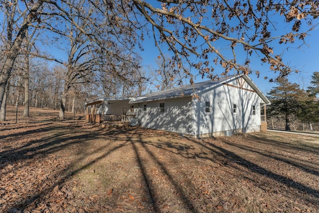 view of side of home with a yard