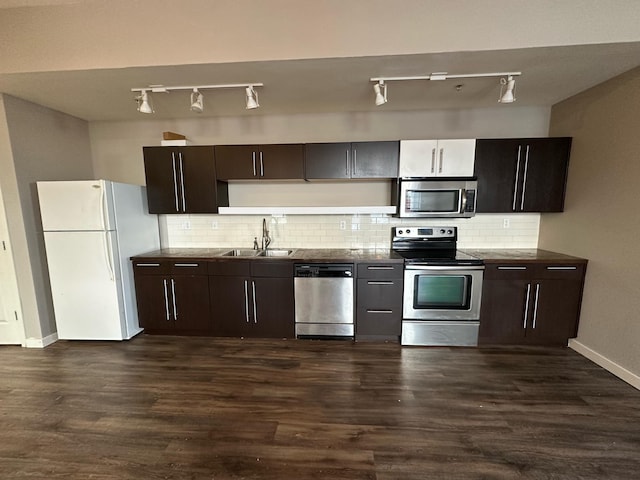 kitchen featuring stainless steel appliances, sink, dark brown cabinetry, and dark hardwood / wood-style flooring