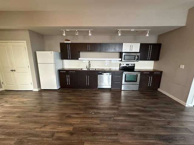 kitchen featuring sink, dark brown cabinets, stainless steel appliances, dark hardwood / wood-style floors, and tasteful backsplash