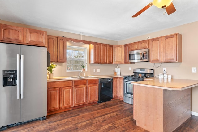 kitchen with appliances with stainless steel finishes, dark hardwood / wood-style floors, sink, ceiling fan, and kitchen peninsula