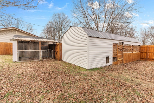 view of outdoor structure with a fenced backyard and an outdoor structure