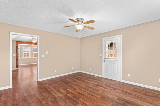 spare room featuring ceiling fan, dark hardwood / wood-style flooring, and a textured ceiling