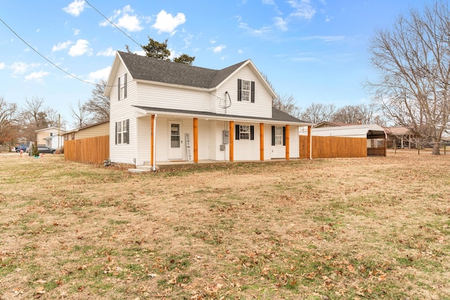 view of front of home featuring covered porch, a shingled roof, a front lawn, and fence