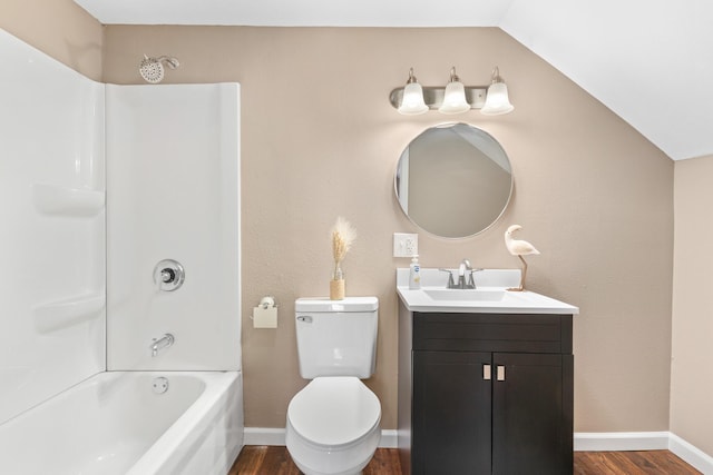 bathroom with tub / shower combination, baseboards, vaulted ceiling, wood finished floors, and vanity