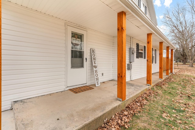 view of exterior entry featuring covered porch