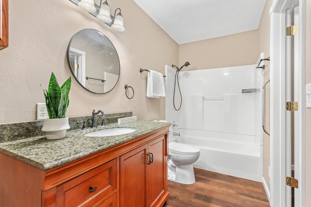 bathroom featuring vanity, shower / bathing tub combination, toilet, and wood finished floors