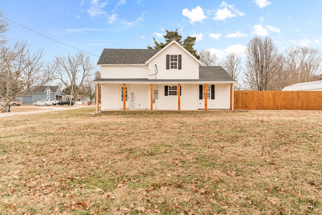 farmhouse featuring a porch and a front yard